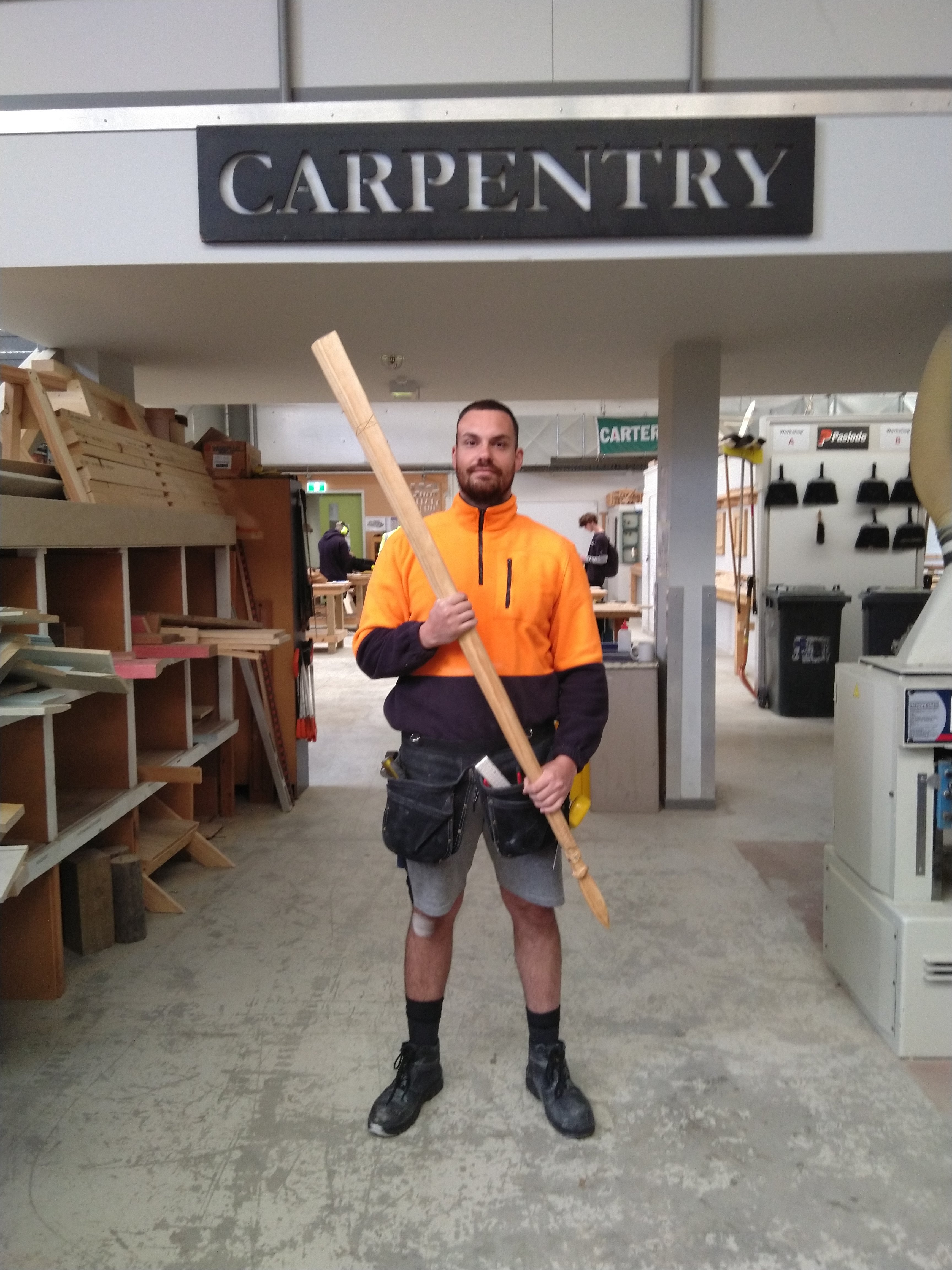 Ian under carpentry sign.jpg